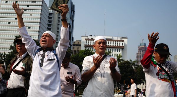 epa10721801 Indonesian muslim protestors shout slogans as they hold copies of the Koran during a protest in Jakarta, Indonesia, 02 July 2023. Dozens of muslim activists in Jakarta staged a protest against Sweden for allowing a protestor to burn a copy of the Koran outside of a mosque in Stockholm.  EPA/ADI WEDA