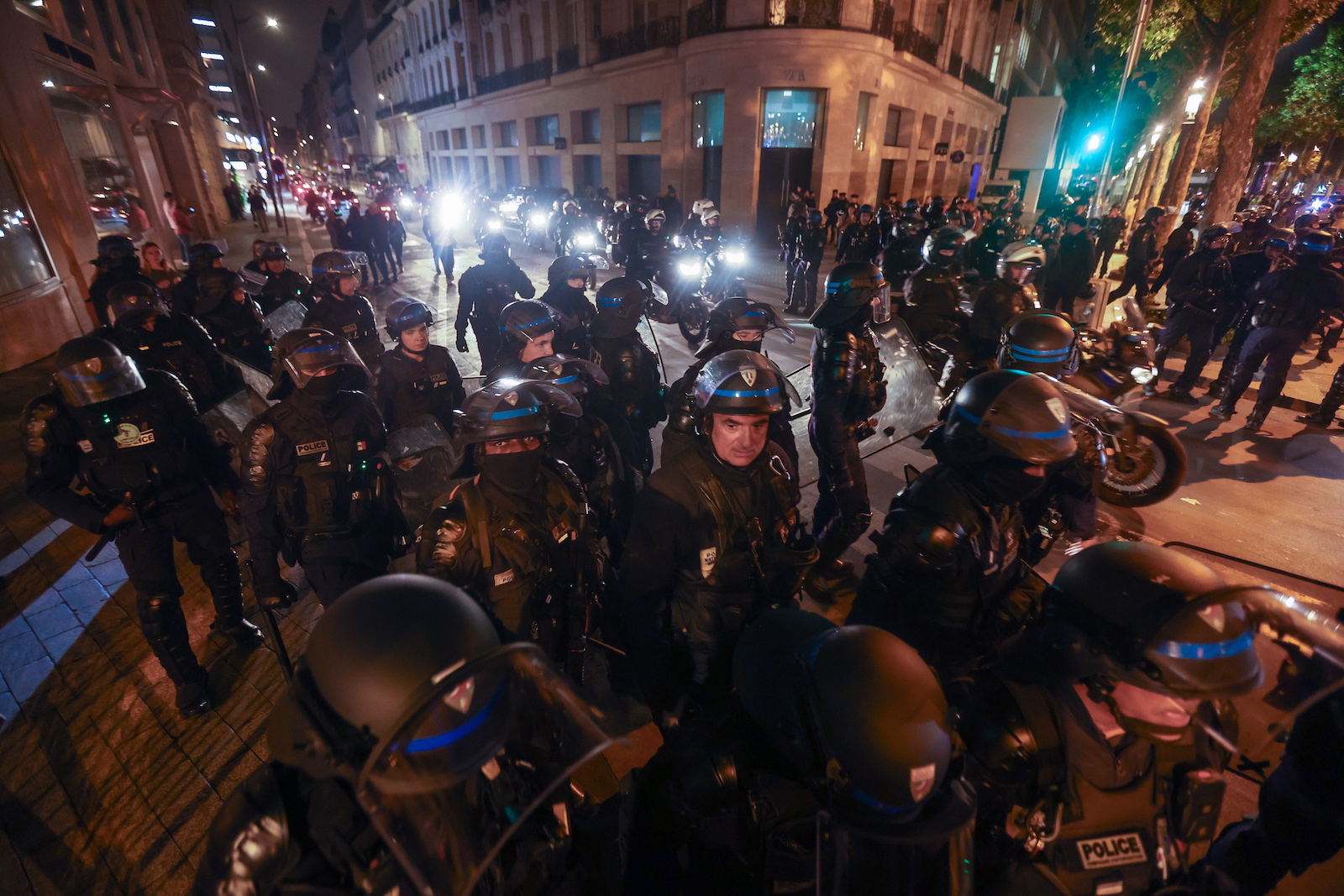 epaselect epa10721741 Riot police forces secure the area near the Arc de triomphe during another night of clashes with protestors in Paris, France, 01 July 2023. Violence broke out all over France after police fatally shot a 17-year-old teenager during a traffic stop in Nanterre on 27 June.  EPA/MOHAMMED BADRA