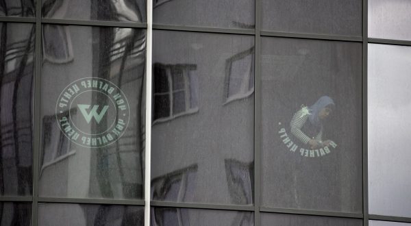 epa10722704 A worker removes the logo of the private military company (PMC) Wagner Group from the windows of the Sea Capital (Morskaya Stolitsa) business center, where Yevgeny Prigozhin's company rented several floors in St. Petersburg, Russia, 02 July 2023. On 23 June 2023, Wagner Group forces led by Prigozhin left the frontline in Ukraine and staged an 'armed mutiny' against Russia's military leadership. Prigozhin claimed on 24 June 2023 that his troops had occupied the headquarters of the Southern Military District in Rostov-on-Don, Russia, a key city near the Ukrainian border. A deal negotiated by the Belarusian president with Prigozhin stopped the Wagner forces' movement toward Moscow and ended the standoff, with Prigozhin and his fighters leaving the country.  EPA/ANATOLY MALTSEV