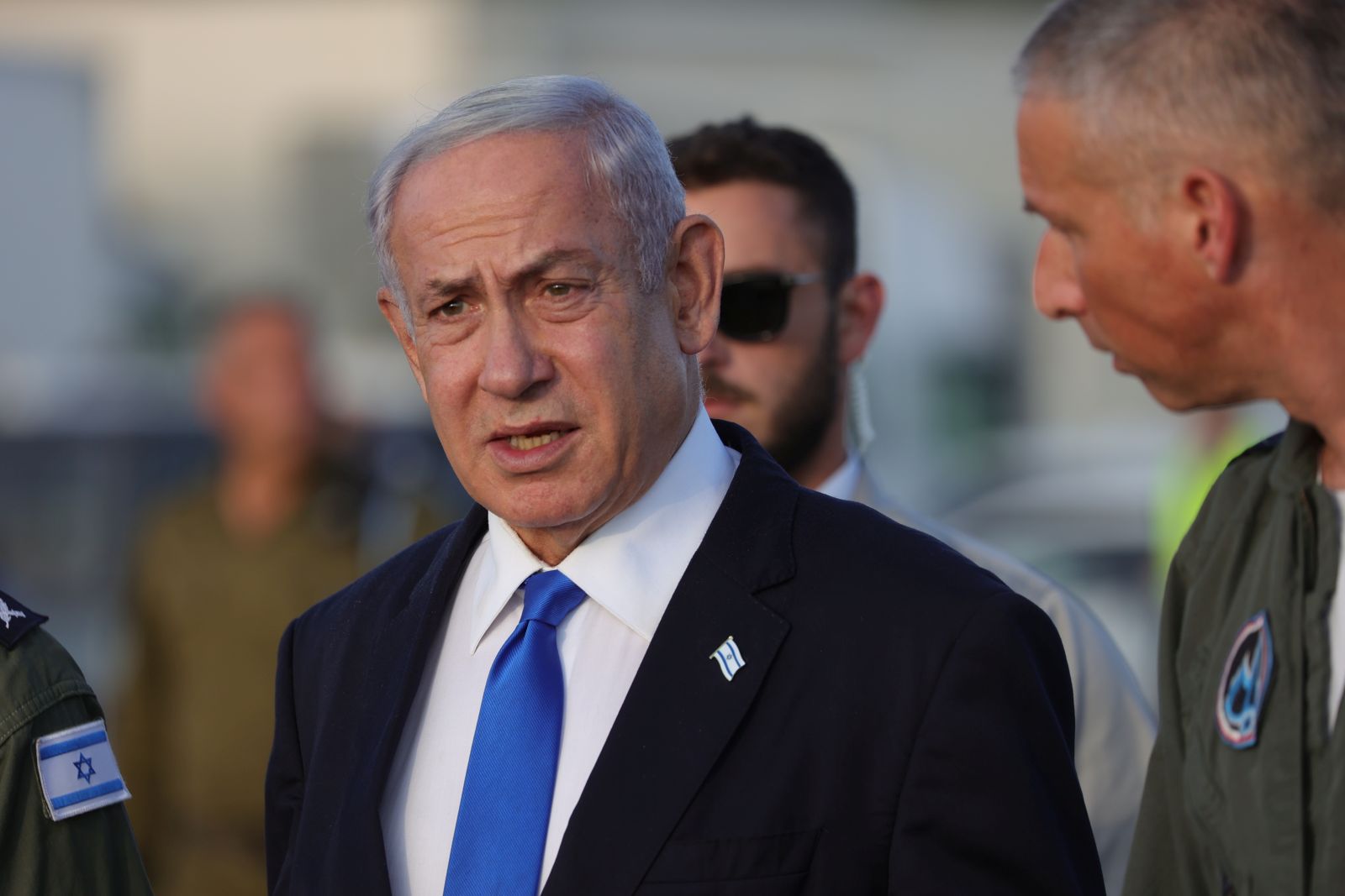 epa10728113 Israeli Prime Minister Benjamin Netanyahu speaks with air force officers during a visit in Palmachim air force base in Rishon Lezion, Israel, 05 July 2023. Netanyahu inspected the air force's array of unmanned aerial vehicles and drones.  EPA/ABIR SULTAN
