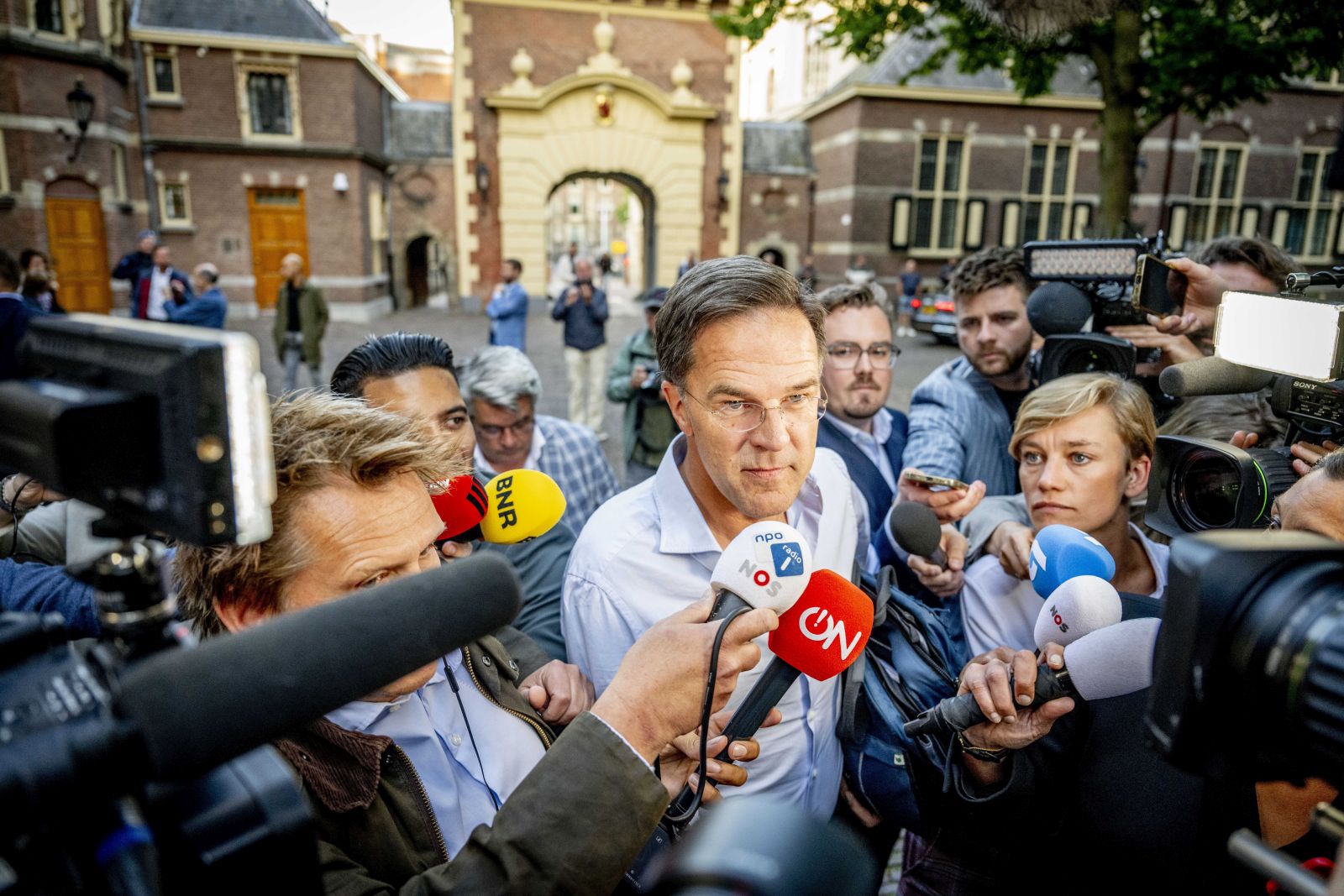 epa10730898 Netherland's Prime Minister Mark Rutte (C) speaks to journalists as he arrives at the General Affairs Ministry to continue consultations on the asylum policy, in The Hague, Netherlands, 06 July 2023. Netherland's government is under great pressure amid difficult negotiations on a migration package, in which the curtailment of the influx of asylum seekers in particular is leading to major tensions between the four coalition parties.