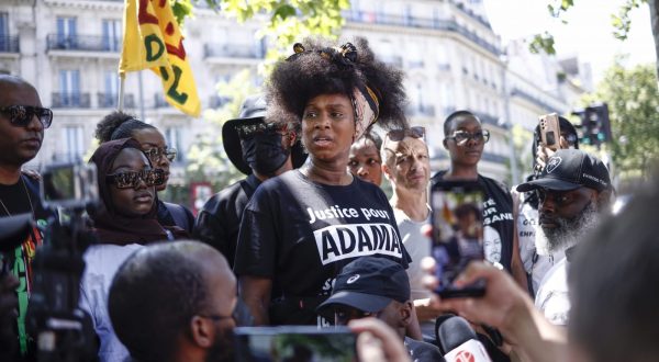 epa10734382 Assa Traore (C), half-sister of Adama Traore delivers a speech during a demonstration against police brutality and racism in Paris, France, 08 July 2023. The protest is organized by supporters of Assa Traore's brother Adama Traore, who died in police custody in 2016, in circumstances that remain unclear.  EPA/YOAN VALAT