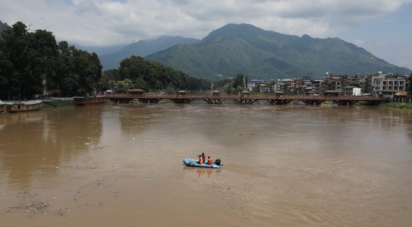 epa10736544 Indian police officers patrol on a boat on Jhelum river in Srinagar, the summer capital of Indian Kashmir, 09 July 2023. The threat of flooding in Kashmir was averted on 09 July as the water level receded in Jhelum river and other major water bodies of the region, while 270-kilometre Srinagar-Jammu highway was closed due to sinking of large portion along the road at Chamba Seri Ramban in the Himalayan region. Over the past three days, Kashmir witnessed heavy rains and a subsquent increase in water level in water bodies. The local meteorological department has forecast an improvement in prevailing weather conditions from 10 July onward.  EPA/FAROOQ KHAN