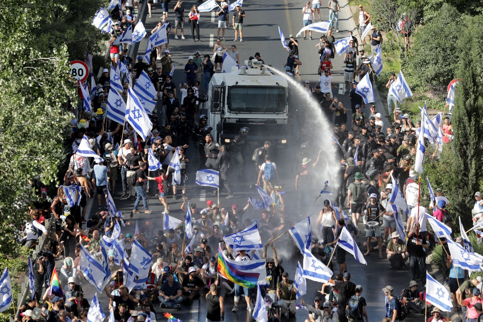 epa10766372 Police officers use a watercannon to attempt to move people blocking the Begin highway as protests continue across the country as the Israeli parliament, or Knesset, passed a bill that would limit the Supreme Court's powers, Jerusalem, 24 July 2023.  EPA/ABIR SULTAN