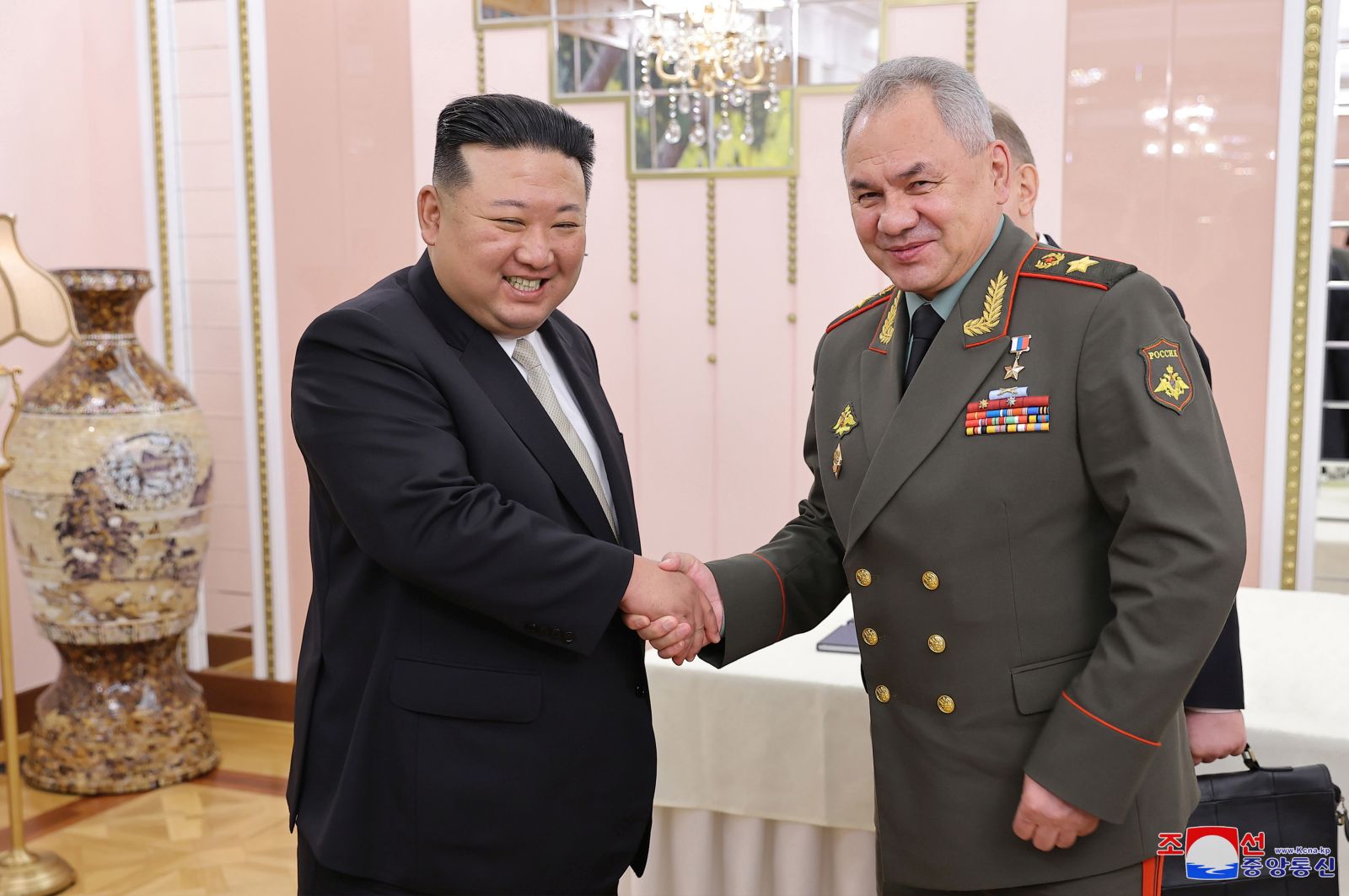 epa10770768 A photo released by the official North Korean Central News Agency (KCNA) shows North Korean Supreme Leader Kim Jong-un (L) shaking hands with Minister of Defense of the Russian Federation Sergei Shoigu (R) during a meeting at the office building of the Party Central Committee in Pyongyang, North Korea, 26 July 2023 (issued 27 July 2023). Shoigu is on a visit to North Korea coinciding with the nation's celebration of the armistice that ceased direct conflict in the 1950-53 Korean War.  EPA/KCNA   EDITORIAL USE ONLY