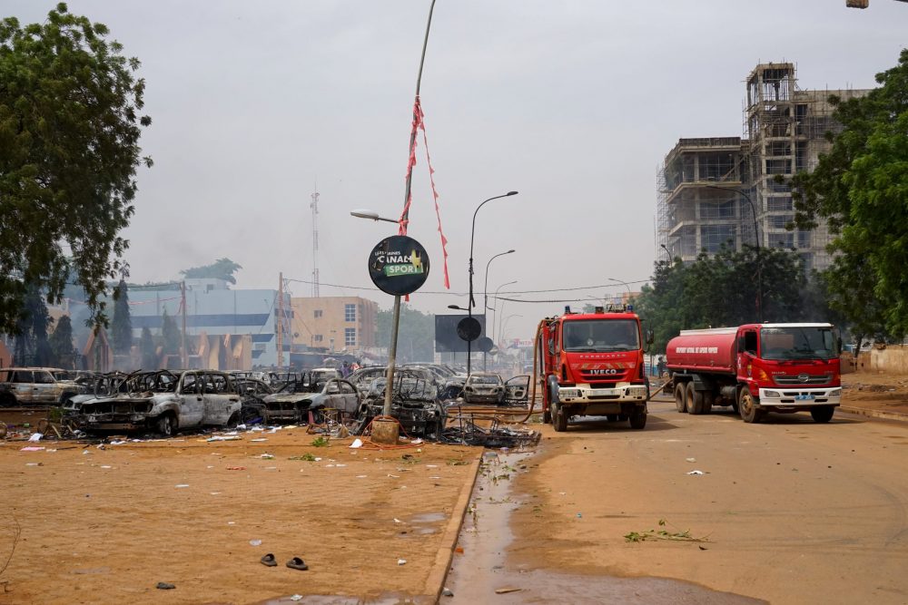 epa10771854 Firefighter trucks next to torched cars at a parking lot near the Nigerien Party for Democracy and Socialism headquarters in Niamey, Niger, 27 July 2023. Mutinous soldiers calling themselves the National Council for the Safeguarding of the Country claimed to have overthrown President Mohamed Bazoum, Niger's democratically elected President, in a Televised address on 26 July evening.  EPA/STR