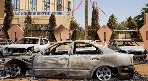 epa10773372 Torched cars sit in front of the headquarters of the Nigerien Party for Democracy and Socialism, which was damaged during anti-government protests in Niamey, Niger, 29 July 2023. Mutinous soldiers calling themselves the 'National Council for the Safeguarding of the Country' claimed to have overthrown President Mohamed Bazoum, Niger's democratically elected president, in a televised address on 26 July evening. Protesters went out on 27 July in the streets of Niamey to support mutinous soldiers and demand the end of foreign intervention in the country. They also set fire to the building housing the headquarters of the ousted president's party.  EPA/ISSIFOU DJIBO