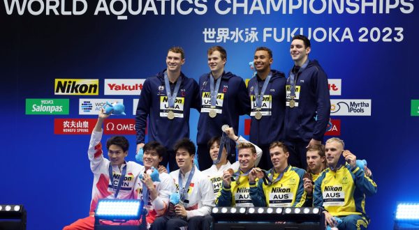 epa10777390 Gold medalists team USA (top) pose with silver medalists team China (front L) and bronze medalists team Australia at the medal ceremony of the Men's 4 x 100m Medley Relay of the Swimming events during the World Aquatics Championships 2023 in Fukuoka, Japan, 30 July 2023.  EPA/KIYOSHI OTA