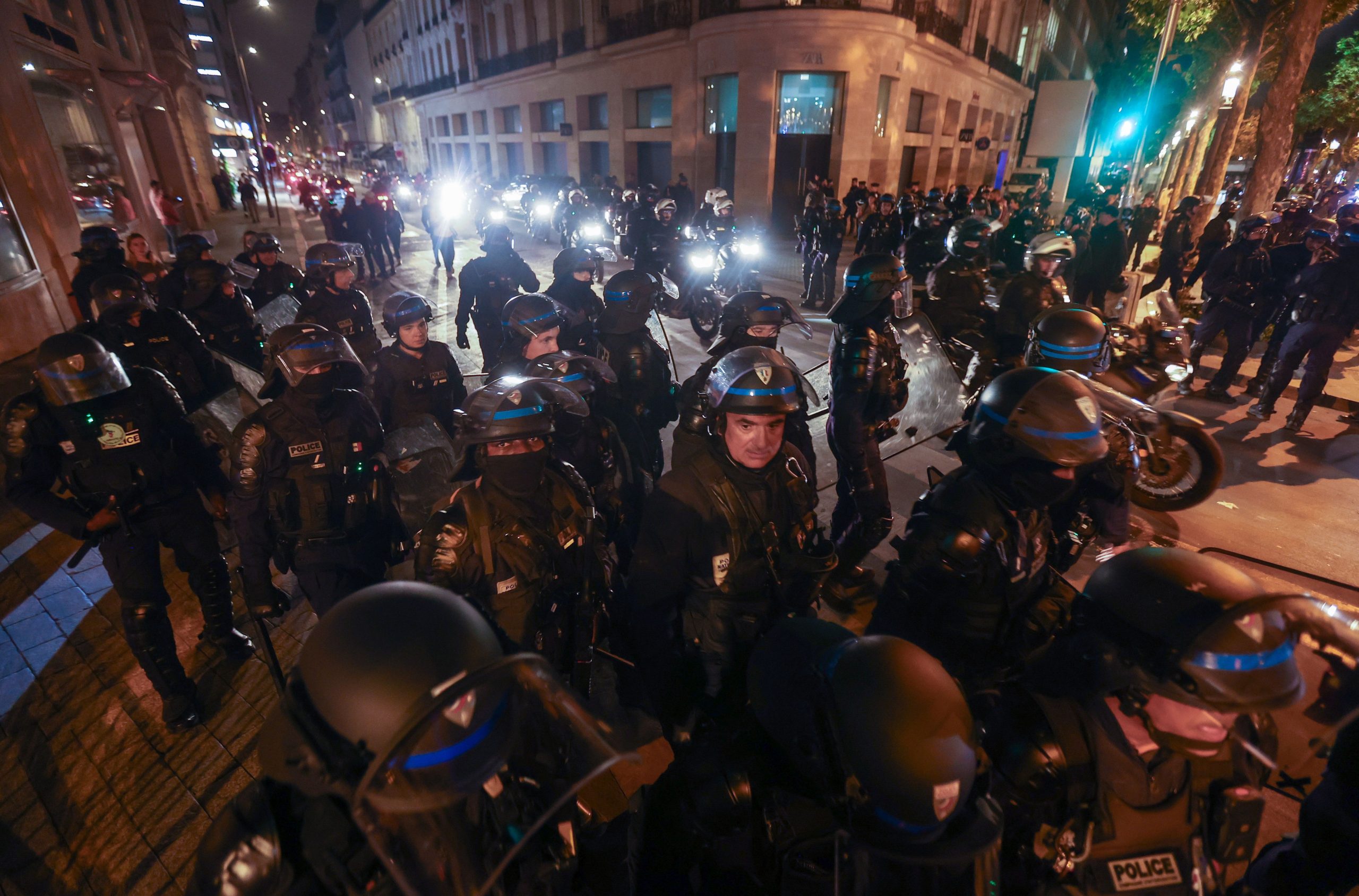 epaselect epa10721741 Riot police forces secure the area near the Arc de triomphe during another night of clashes with protestors in Paris, France, 01 July 2023. Violence broke out all over France after police fatally shot a 17-year-old teenager during a traffic stop in Nanterre on 27 June.  EPA/MOHAMMED BADRA