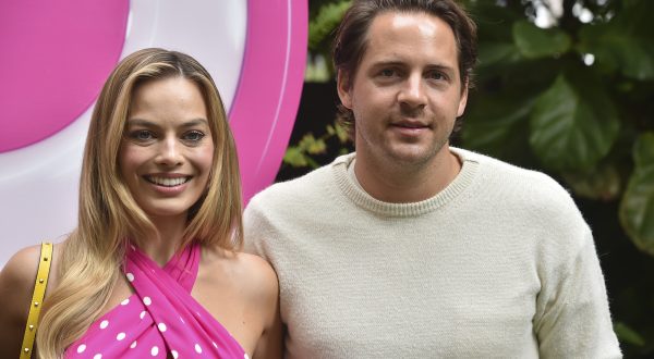 Margot Robbie, left, and Thomas Ackerley arrive at a photo call for "Barbie," Sunday, June 25, 2023, at the Four Seasons Hotel in Los Angeles. (Photo by Jordan Strauss/Invision/AP)