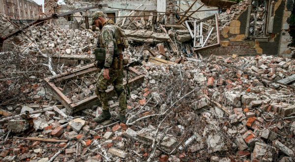 epa10758513 A Ukrainian serviceman of the 24 separate mechanized brigade named after King Danylo, walks amid the ruins of a building destroyed by Russian missile strikes in the Donetsk region, Ukraine, 20 July 2023. The war in Ukraine, which started when Russia entered the country in February 2022, marked in July its 500th day. According to the UN, since the conflict started, more than 9000 civilians have been killed and more than 6 million others are now refugees worldwide.  EPA/OLEG PETRASYUK