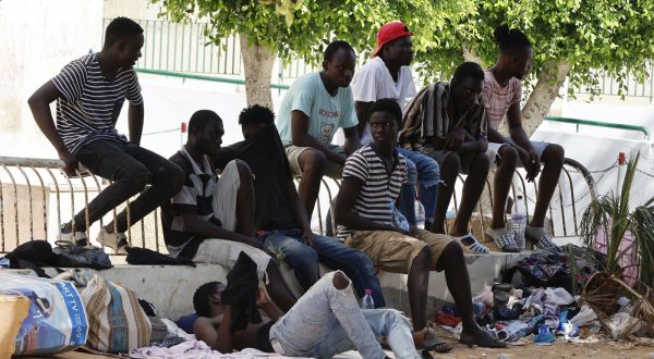 epa10760599 Sub-Saharan African migrants gather in a public garden in Sfax, in the south of Tunis, Tunisia, 21 July 2023. According to the Red Crescent, in Sfax, the second most important city in Tunisia, almost 1.500 Sub-Saharan African migrants, including children, try to find the shadow and water to survive in a public garden for two weeks. Most of them entered Tunisia in an unauthorized way and come from Sudan, Nigeria, Liberia, Mali, Burkina Faso and Guinea. According to the nongovernmental group Tunisian Forum for Economic and Social Rights (FTDES), between January and May 2023, Tunisian authorities arrested over 3,500 migrants for 'irregular stay' and intercepted over 23,000 people attempting irregular departures from Tunisia.  EPA/MOHAMED MESSARA
