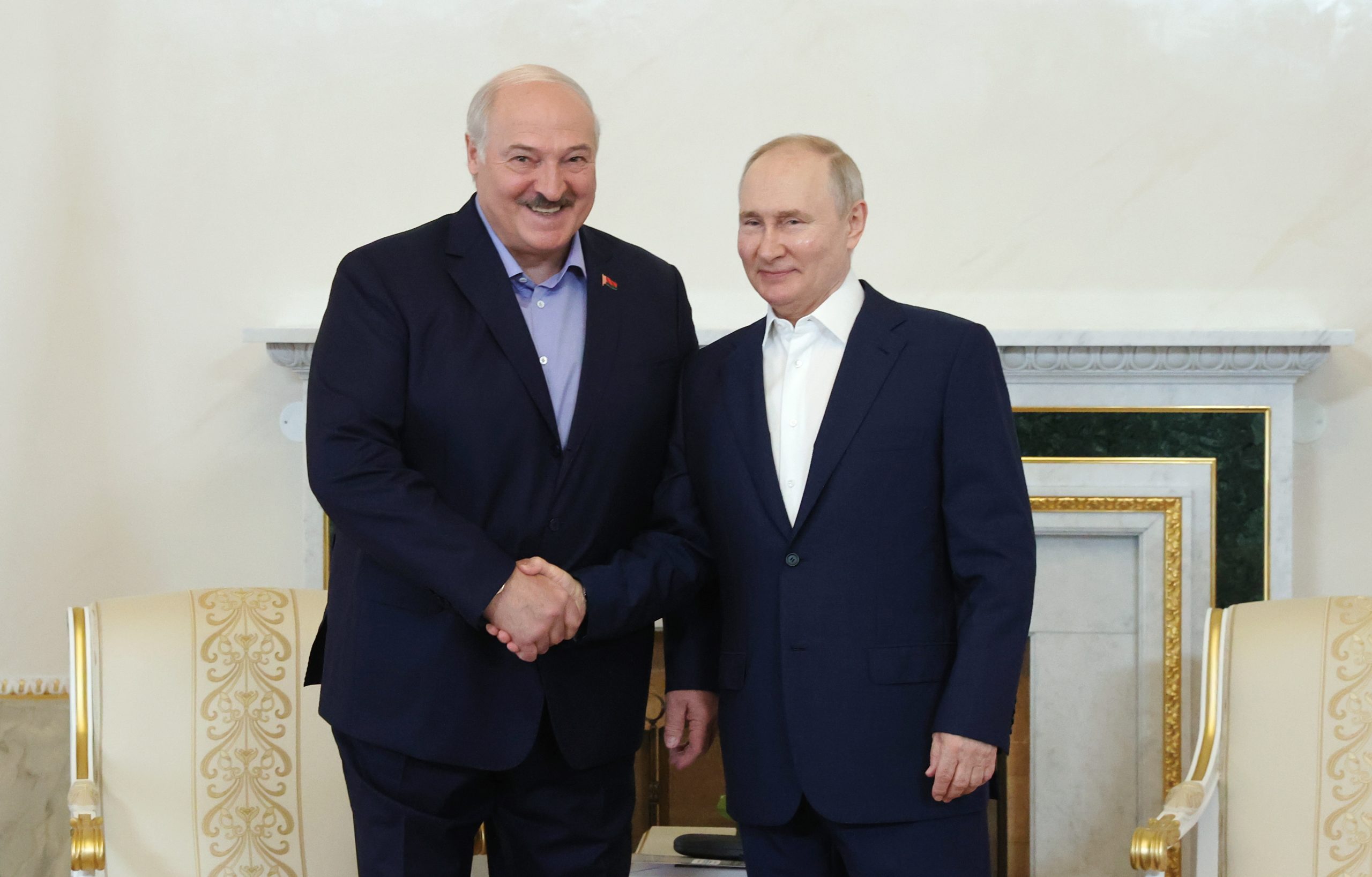 epa10763679 Russian President Vladimir Putin (R) shakes hands with his Belarusian counterpart Alexander Lukashenko in St. Petersburg, Russia, 23 July 2023. Alexander Lukashenko is on working visit to Russia.  EPA/ALEXANDER DEMYANCHUK / KREMLIN / POOL