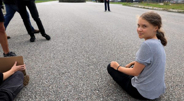 epa10766182 Swedish climate activist Greta Thunberg  prostests by blocking the entrance to Oljehamnen neighbourhood in Malmo, Sweden, 24 July 2023. Thunberg was convicted and ordered to pay a fine earlier in the day after an action at Oljehamnen on June 19th when police removed Thunberg from the scene.  EPA/Andreas Hillergren SWEDEN OUT