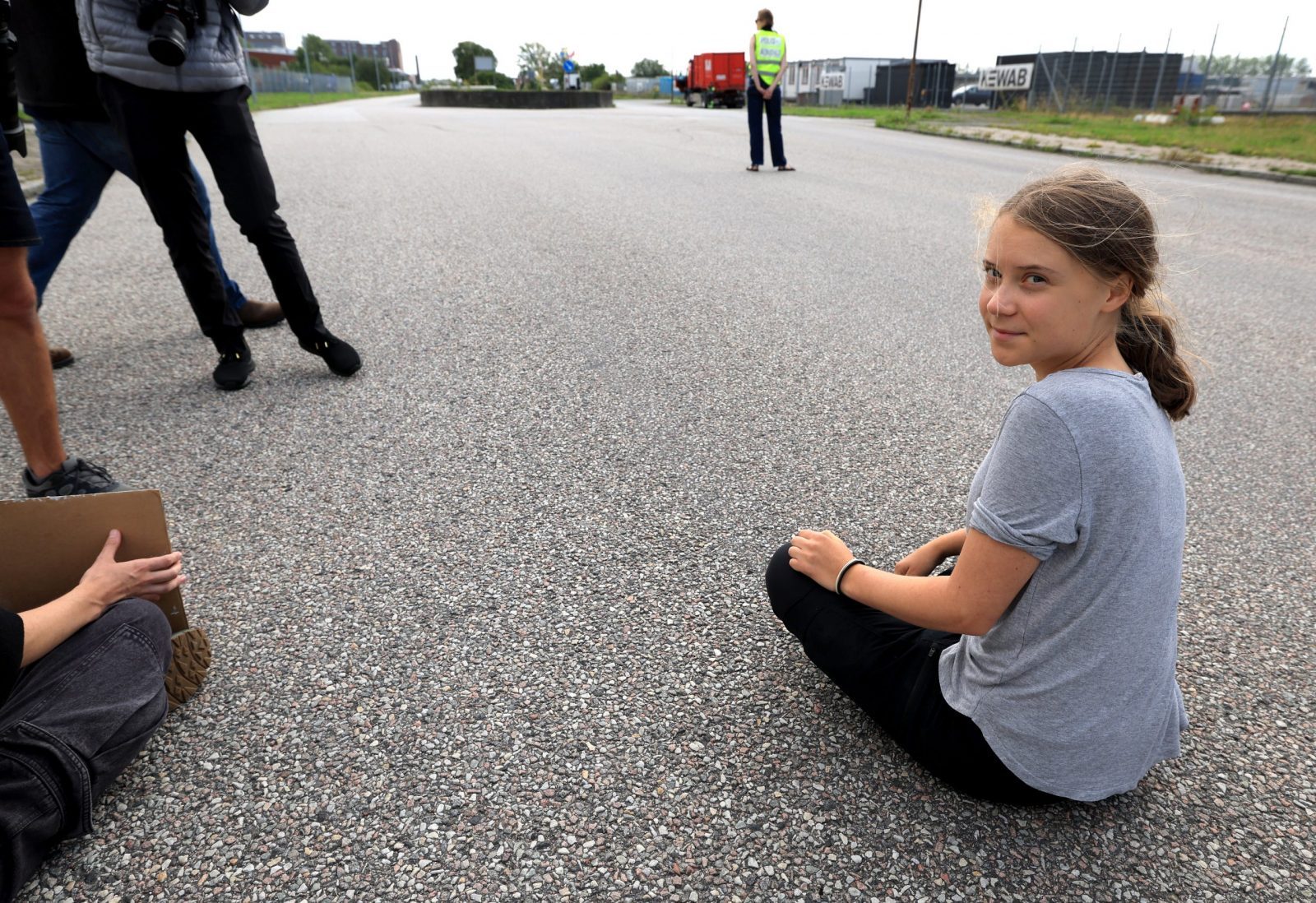 epa10766182 Swedish climate activist Greta Thunberg  prostests by blocking the entrance to Oljehamnen neighbourhood in Malmo, Sweden, 24 July 2023. Thunberg was convicted and ordered to pay a fine earlier in the day after an action at Oljehamnen on June 19th when police removed Thunberg from the scene.  EPA/Andreas Hillergren SWEDEN OUT