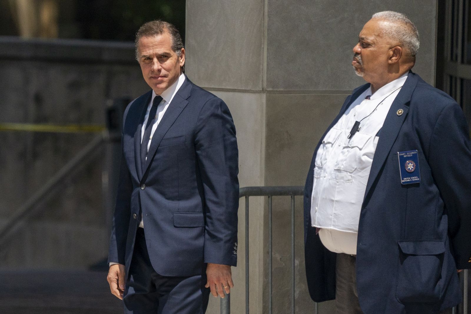 epa10770130 Hunter Biden (L) departs the US Federal District Court in Wilmington, Delaware, USA, 26 July 2023. Hunter Biden's hearing ended with him pleading not guilty after US District Judge Maryellen Noreika said she was not ready to accept the plea deal.  EPA/SHAWN THEW