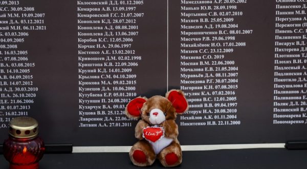 epa10771406 A candle a toy are placed near the list of children who died in the Donbas territory since 2014, during an event in their memory, in front of the US embassy in Moscow, Russia, 27 July 2023. On 27 July, the self-procalimed Donetsk People's Republic celebrates the Day of Remembrance of the Children Victims of the War in Donbass. According to its Commissioner for Human Rights Darya Morozova, as of 20 July 2023, some 228 children died in the territory of Donbass during the entire period of the armed conflict  EPA/YURI KOCHETKOV