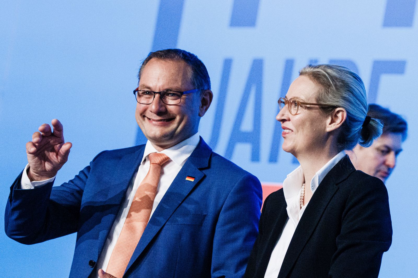 epa10773035 Alternative for Germany (AfD) party co-chairman and spokesman Tino Chrupalla (L) waves next to AfD deputy chairwoman Alice Weidel during the AfD party convention in Magdeburg, Germany, 28 July 2023. The Alternative for Germany (AfD) 14th federal party congress takes place in Magdeburg on 28 July, followed by a five-day European Elections assembly.  EPA/CLEMENS BILAN