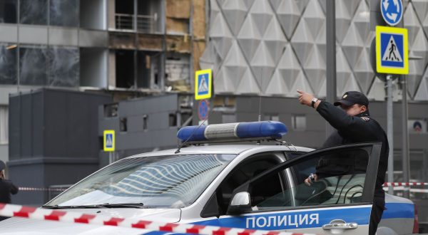epa10776519 A police officer gestures near a cordon at the site of a damaged building following a reported drone attack in Moscow, Russia, 30 July 2023. The Russian Ministry of Defense on 30 July accused Ukraine of carrying out an attack with three unmanned aerial vehicles (UAV) against facilities in Moscow, adding that the attack was foiled and the three UAVs 'were suppressed by means of electronic warfare and crashed' leaving no casualties.  EPA/YURI KOCHETKOV