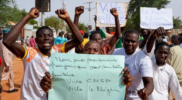 epa10777381 Protesters display a sign that reads ‘No to French mercenaries on our soil, long live CNSP, long live Niger’ during a protest in Niamey, Niger, 30 July 2023. Thousands of supporters of General Abdourahamane Tchiani, head of the Presidential Guard, who declared himself the new leader of Niger after a coup against democratically elected President Mohamed Bazoum on 26 July, took to the streets of Niamey to demonstrate support for the coup.  EPA/ISSIFOU DJIBO