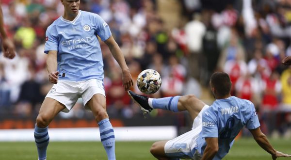 epa10787683 Mateo Kovacic (R) and Erling Haaland (L) of Manchester City in action during the FA Community Shield soccer match between Arsenal London and Manchester City in London, Britain, 06 August 2023.  EPA/TOLGA AKMEN