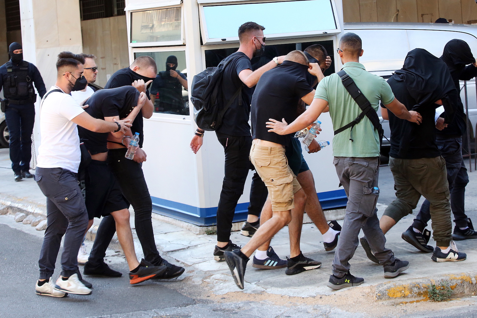 epa10794632 Hooligans, who were arrested after violent clashes between AEK and Dinamo Zagreb supporters in Athens, are transferred by police officers to appear before an interrogator, in Athens, Greece, 11 August 2023. The first of the over 100 people, mostly Croatian nationals, charged in connection with the violence around the AEK Athens stadium on the night of 07 August are to begin appearing before three examining magistrates assigned to the case. The list of charges also includes the murder of 29-year-old AEK fan Michalis Katsouris but none of the suspects has been charged with the killing so far as the perpetrator has yet to be identified.  EPA/ORESTIS PANAGIOTOU