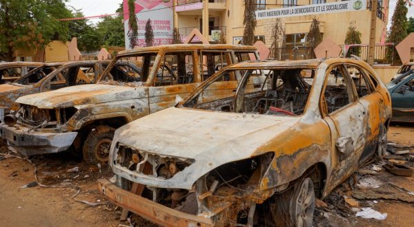 epaselect epa10795499 Burnt-out vehicles sit in front of the Nigerien Party for Democracy and Socialism (PNDS-Tarayya), the party of ousted President Mohamed Bazoum, in Niamey, Niger, 11 August 2023. The leaders of the Economic Community of West African States (ECOWAS) have approved the deployment of a 'standby force to restore constitutional order' in Niger, two weeks after democratically elected President Bazoum was ousted in a coup lead by General Abdourahmane Tchiani, head of the presidential guard.  EPA/ISSIFOU DJIBO