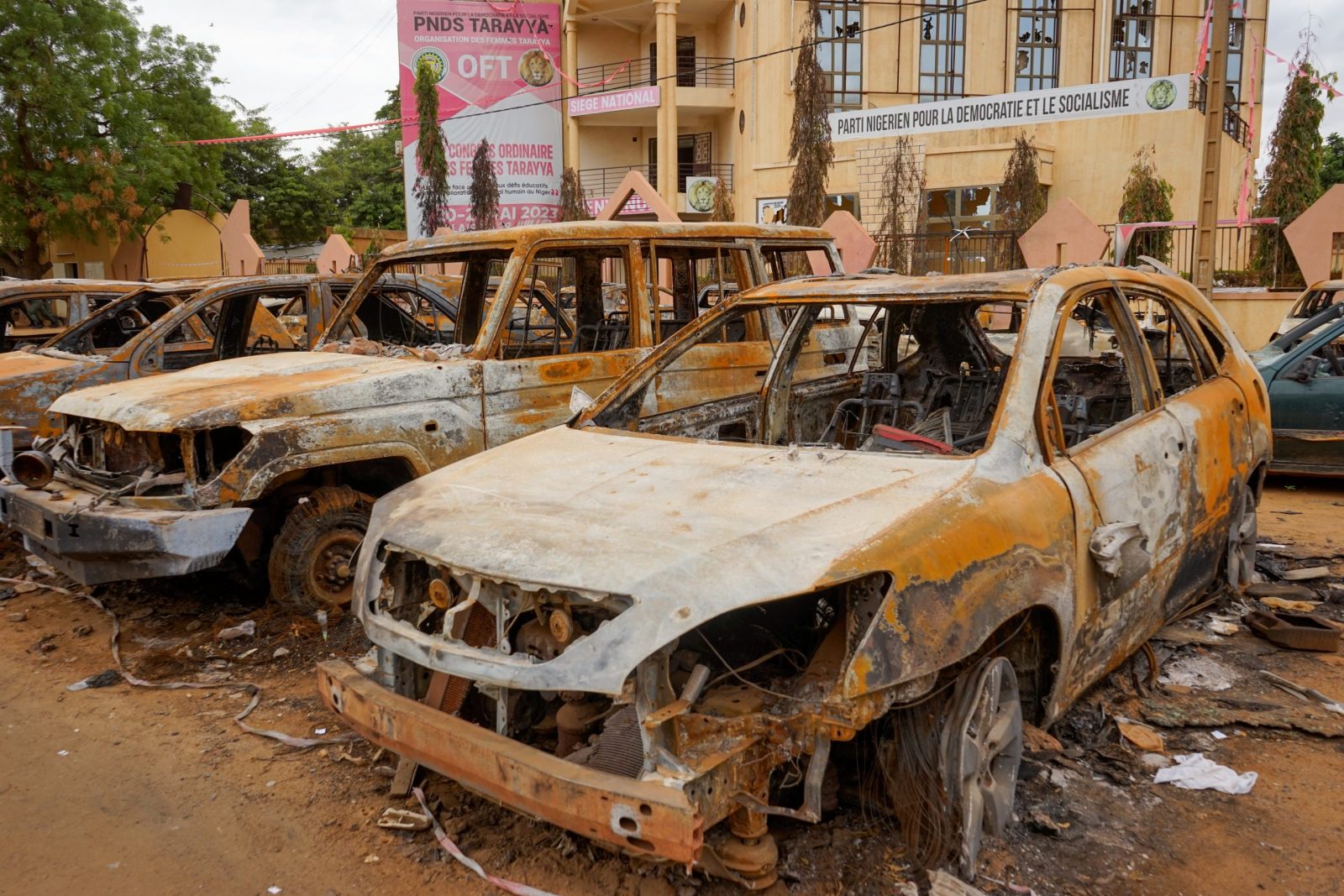 epaselect epa10795499 Burnt-out vehicles sit in front of the Nigerien Party for Democracy and Socialism (PNDS-Tarayya), the party of ousted President Mohamed Bazoum, in Niamey, Niger, 11 August 2023. The leaders of the Economic Community of West African States (ECOWAS) have approved the deployment of a 'standby force to restore constitutional order' in Niger, two weeks after democratically elected President Bazoum was ousted in a coup lead by General Abdourahmane Tchiani, head of the presidential guard.  EPA/ISSIFOU DJIBO