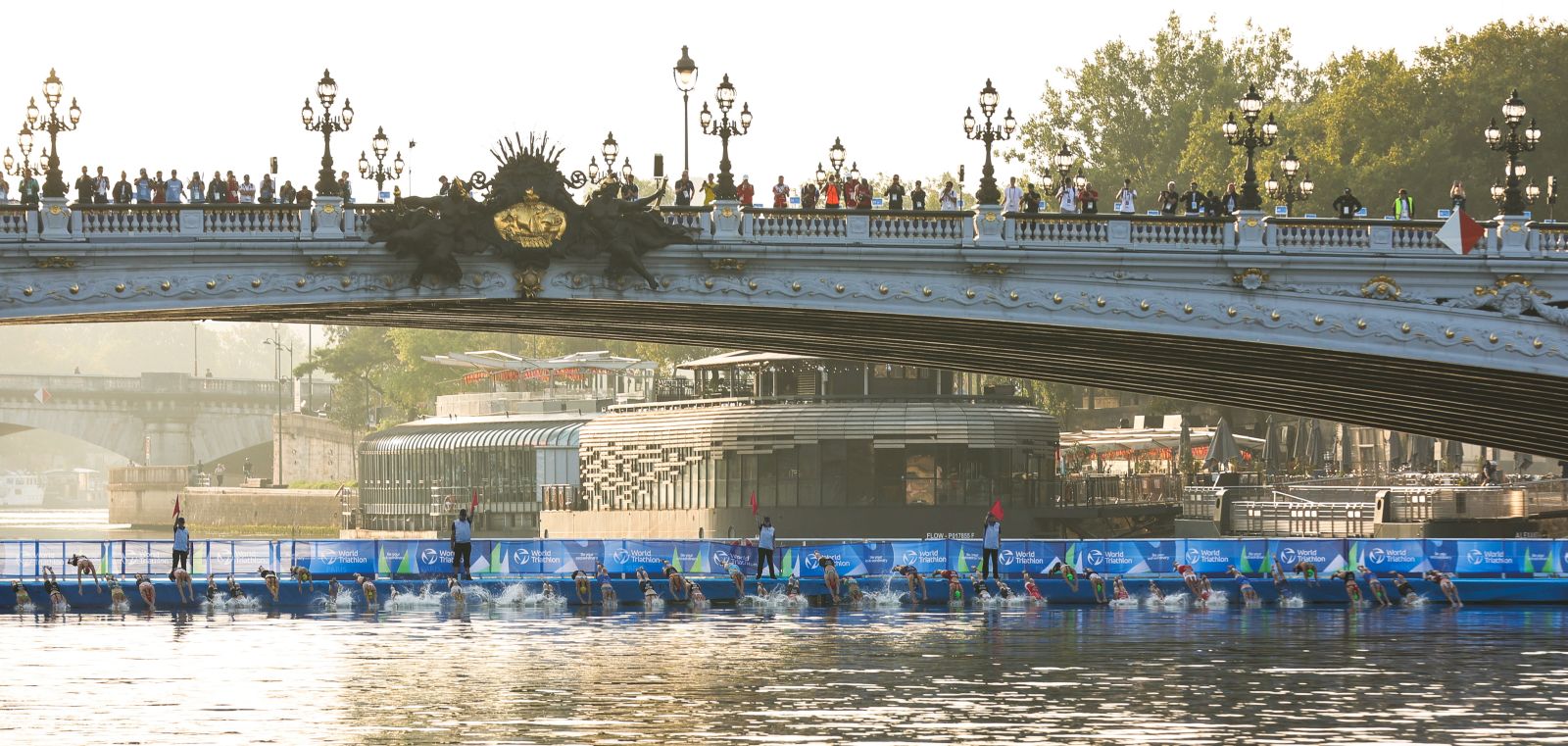 epa10803841 Athletes compete in the Seine river in the swimming during a triathlon competition in the surroundings of the Pont Alexandre III bridge in Paris, France, 17 August 2023. From 17 to 20 August, Paris will be hosting the triathlon and para-triathlon test event for the Paris 2024 Olympic Games. 240 athletes are taking part in this test event where the results will be taken into account in the World Triathlon rankings for Olympic qualification.  EPA/TERESA SUAREZ