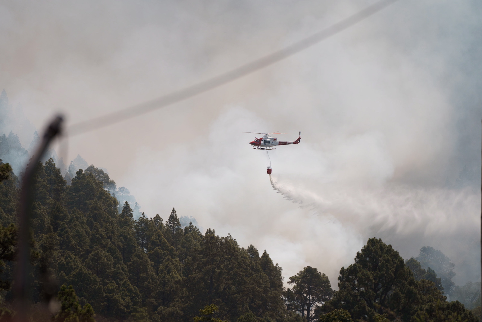 epa10805597 Helicopters work to extinguish a forest fire burning out of control in the area of La Orotava, Spain, 18 August 2023. The fire, first detected on 15 August, had already burnt over 3,500 hectares of land within a 42-kilometer radius, forcing inhabitants from nearby areas to stay confined in their homes or even evacuate.  EPA/RAMON DE LA ROCHA