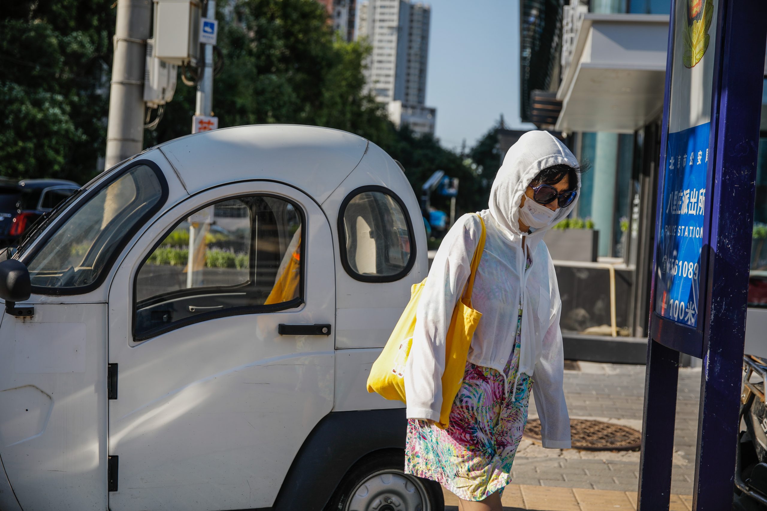 epa10811387 A woman wearing a face mask walks on a street in Beijing, China, 21 August 2023. The EG.5 substrain of the Omicron variant has became the most prominent source of COVID-19 infections across China, as the number of infections caused by EG.5 has risen to 71.6 percent in August from just 0.6 percent in the month previously, said the Chinese Center for Disease Control and Prevention on 19 August.  EPA/WU HAO