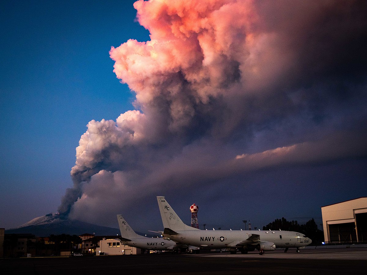 SIGONELLA, Italy (Feb. 16, 2021) Mt. Etna lets off some steam in the background of P-8A Poseidon maritime patrol aircraft assigned to the "Grey Knights" of Patrol Squadron (VP) 46, Feb. 16, 2021. VP-46 is currently forward-deployed to the U.S. 6th Fleet area of operations and is assigned to Commander, Task Force 67, responsible for tactical control of deployed maritime patrol and reconnaissance squadrons throughout Europe and Africa. U.S. 6th Fleet, headquartered in Naples, Italy, conducts a full spectrum of joint and naval operations, often in concert with allied and interagency partners, in order to advance U.S. national security interests and stability in Europe and Africa. (U.S. Navy photo by Mass Communication Specialist 2nd Class Austin Ingram) 210216-N-VH871-1048