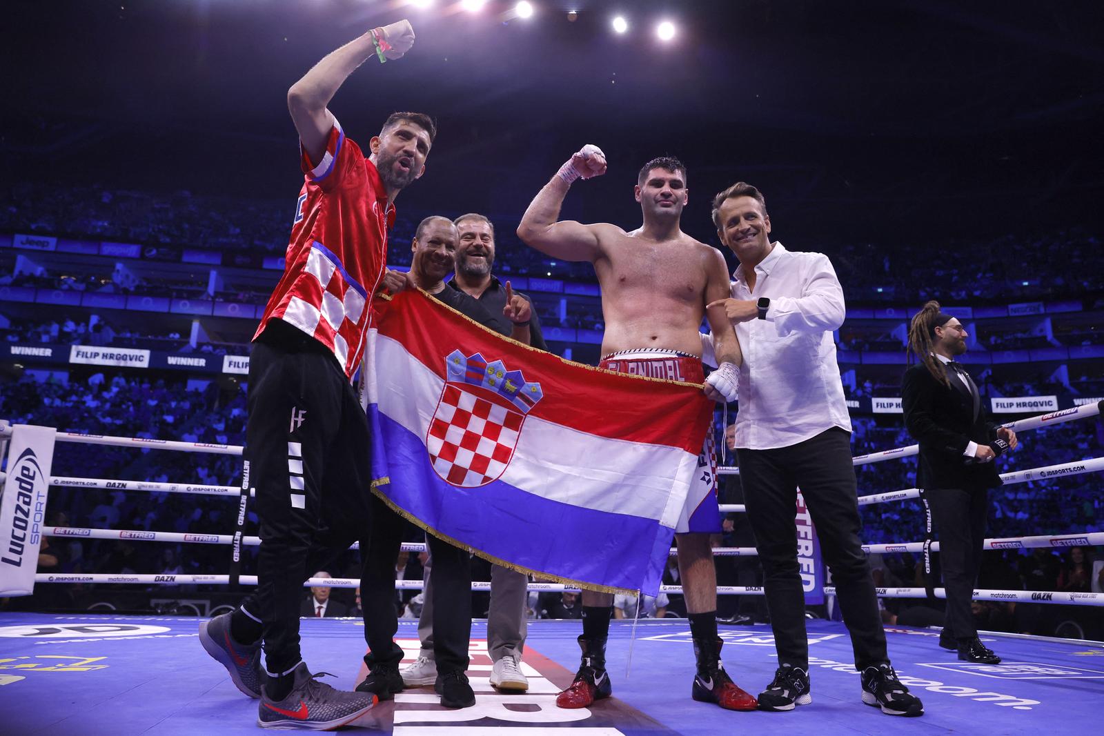 Boxing - Filip Hrgovic v Demsey McKean - O2 Arena, London, Britain - August 12, 2023 Filip Hrgovic celebrates winning his fight against Demsey McKean with trainers Action Images via Reuters/Andrew Couldridge Photo: Andrew Couldridge/REUTERS