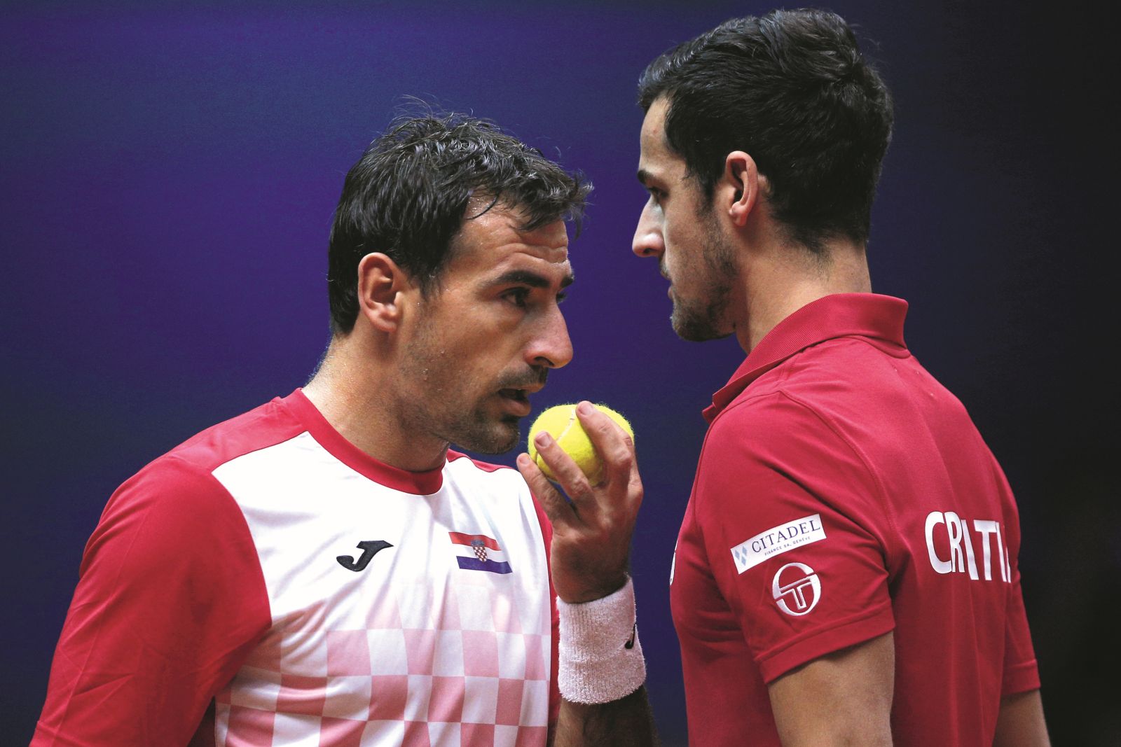 Croatia's Ivan Dodig, left, and Mate Pavic talk during the Davis Cup final between France and Croatia, Saturday, Nov. 24, 2018 in Lille, northern France. Croatia is within one point of a second Davis Cup title after Borna Coric and Marin Cilic dispatched their French rivals in the opening singles matches of the final to take a 2-0 lead. (AP Photo/Thibault Camus)