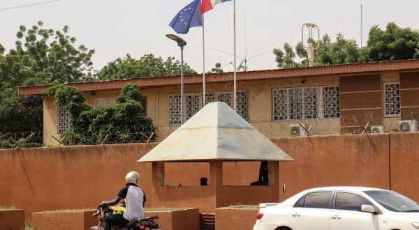 epa10825593 Motorists drive past as the French and European flags fly atop the French embassy compound, in Niamey, Niger, 28 August 2023. The French ambassador to Niger is still in post in Niamey despite being given a 48-hour deadline to leave the country on 25 August by the junta leaders, the French President Emmanuel Macron confirmed in his speech during the annual ambassadors' conference in Paris.  EPA/ISSIFOU DJIBO