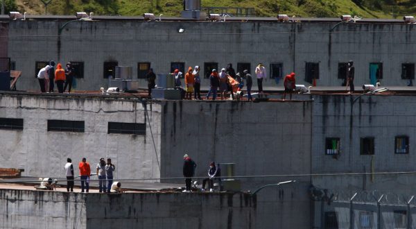epa10829698 Prisoners on the roofs of El Turi prison, in the city of Cuenca, Ecuador, 30 August 2023. Prisoners from Cuenca and Azogues jails rioted in protest against the intervention of the Police and the Armed Forces in the Latacunga prison, as part of a series of operations being carried out to seize weapons in prisons, in the framework of a state of emergency decreed by the government.  EPA/Robert Puglla