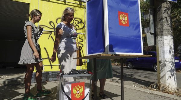 epa10831652 Women cast their ballots at a mobile polling station with the coat of arms of Russia during early voting for the local elections in Mariupol, Russian-controlled Ukraine, 31 August 2023. Elections of various levels will be held in Russia on 10 September 2023, including by-elections of deputies to the State Duma, elections of heads of 26 constituent entities of the federation, and elections of deputies of legislative bodies of state power in 16 constituent entities of the Russian Federation. The Central Election Commission of Russia has scheduled elections in the self-proclaimed Donetsk People’s Republic, Luhansk, Zaporizhzhia and Kherson regions on a Single Voting Day on 10 September.  EPA/STRINGER