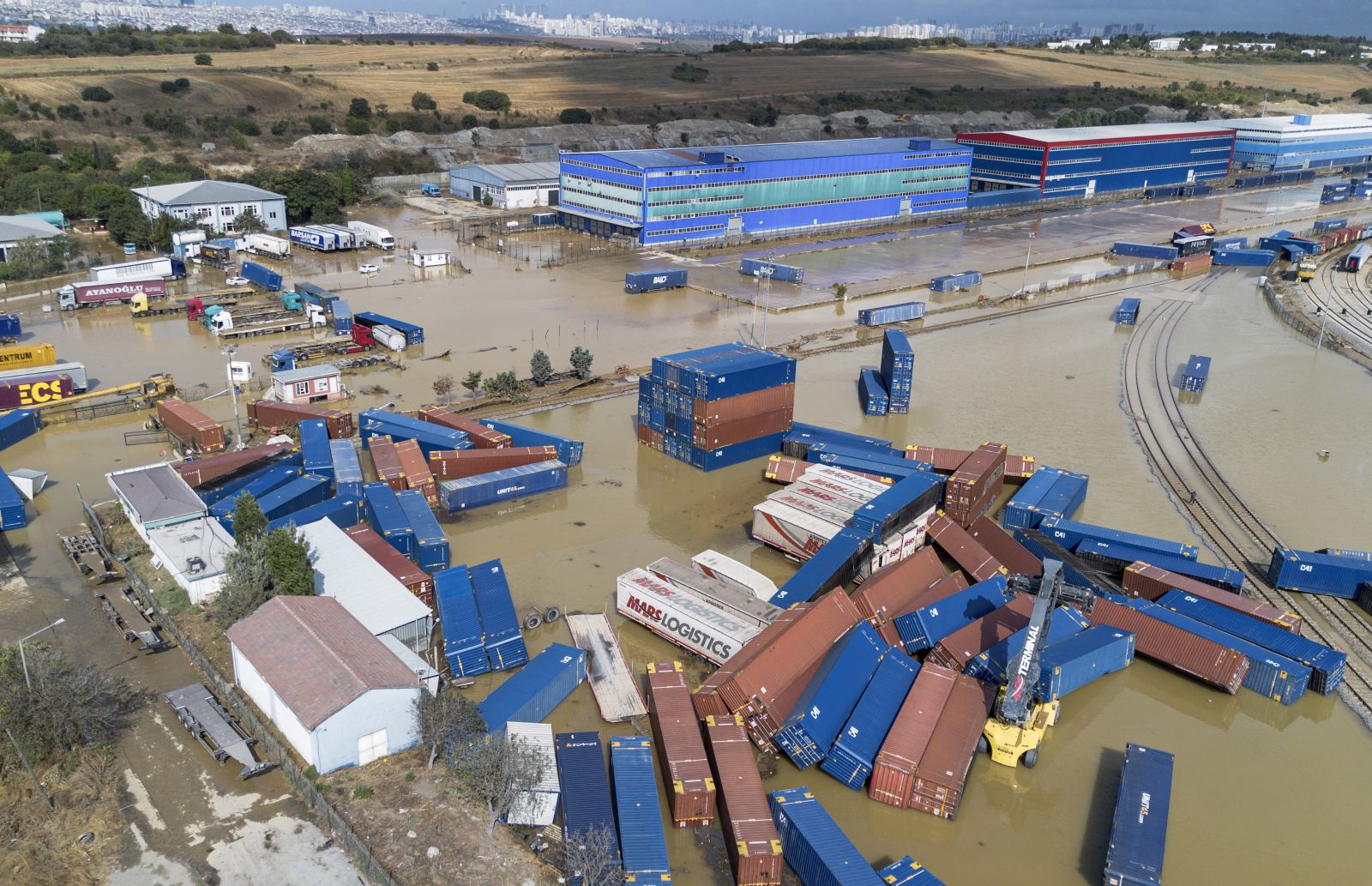 epa10843280 An image taken with a drone shows containers in the floodwaters at the Halkali Customs after floods hit the west districts of Istanbul, Turkey, 06 September 2023. According to the Istanbul Governor's Office, two people died and 12 were wounded because of flooding in the Basaksehir and Kucukcekmece districts.  EPA/ERDEM SAHIN