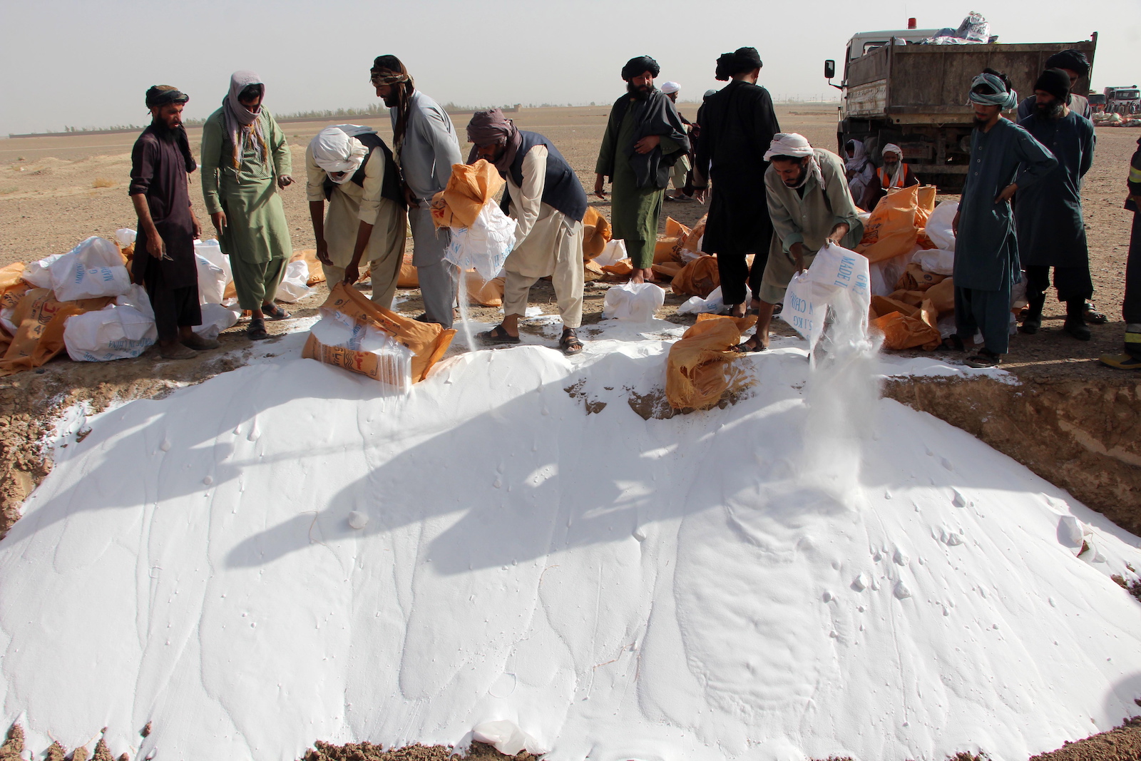 epa10845174 Afghani officials destroy narcotics and illegal substances during a ceremony in Kandahar, Afghanistan, 06 September 2023. Taliban authorities under the anti-narcotics management of the Security Command in Kandahar destroyed 29,385 kgs of various narcotics. Taliban leader Sheikh Haibatullah Akhund oversaw the disposal of 12 types of drugs at the Kandahar Police Headquarters, including 260 kg of heroin, 182 kg of glass drug, 1,776 kg of hashish, 108 kg of morphine, 4.66 kg of tablets and 635 liters of alcoholic beverages among other items.  EPA/STRINGER
