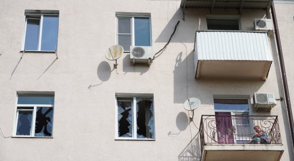 epa10845629 A local woman sits on the balcony of her damaged apartment following a drone attack in downtown Rostov-on-Don, Russia, 07 September 2023. Russian Air defense systems shot down one drone on approach to Rostov-on-Don, and the second in the city center, said the governor of the Golubev region. On Pushkinskaya Street, the facades of several buildings were damaged, the windows of three buildings were shattered, and several cars were damaged. Traffic in the area of the incident was limited. As a result of damage to an electrical panel in the area of the incident, 20 houses remain without electricity.  EPA/STRINGER