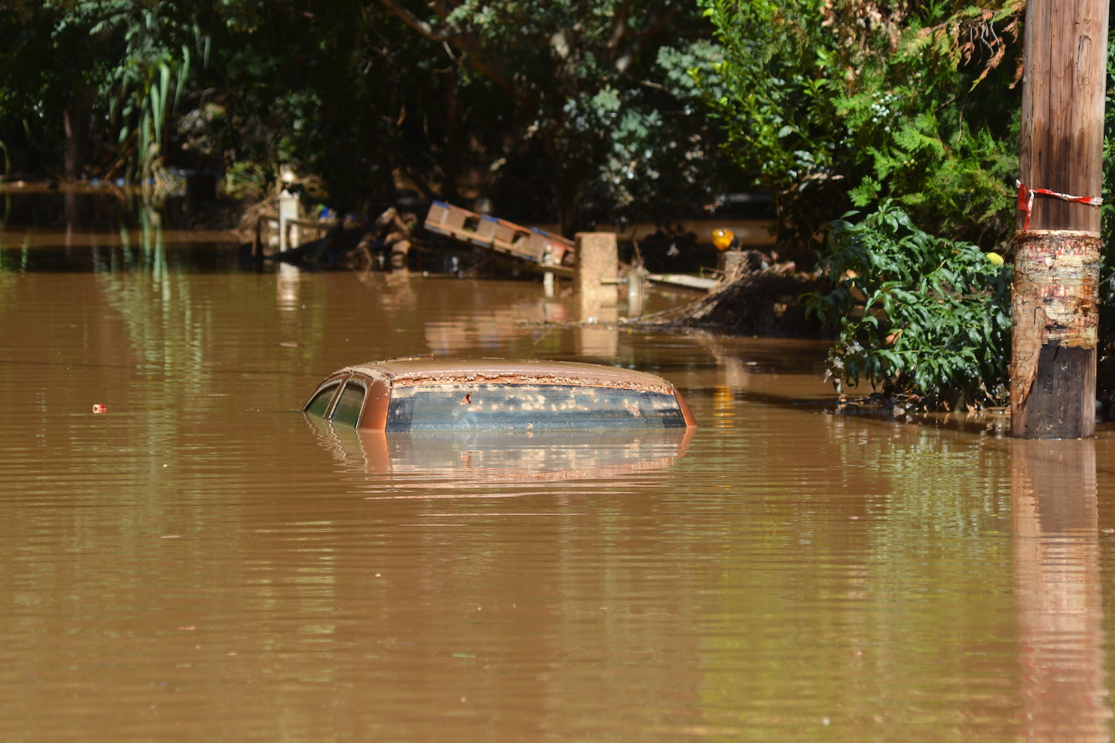 epa10854580 A car submerged in water near Larissa, after storm Daniel swept across central Greece, 11 September 2023. Several neighbourhoods within the city of Larissa remain flooded, with the level of the water undiminished, while the damage is extensive and there are public health fears due to pollution, including of the water table. The death toll from floods in Greece has risen to 15.  EPA/APOSTOLIS DOMALIS