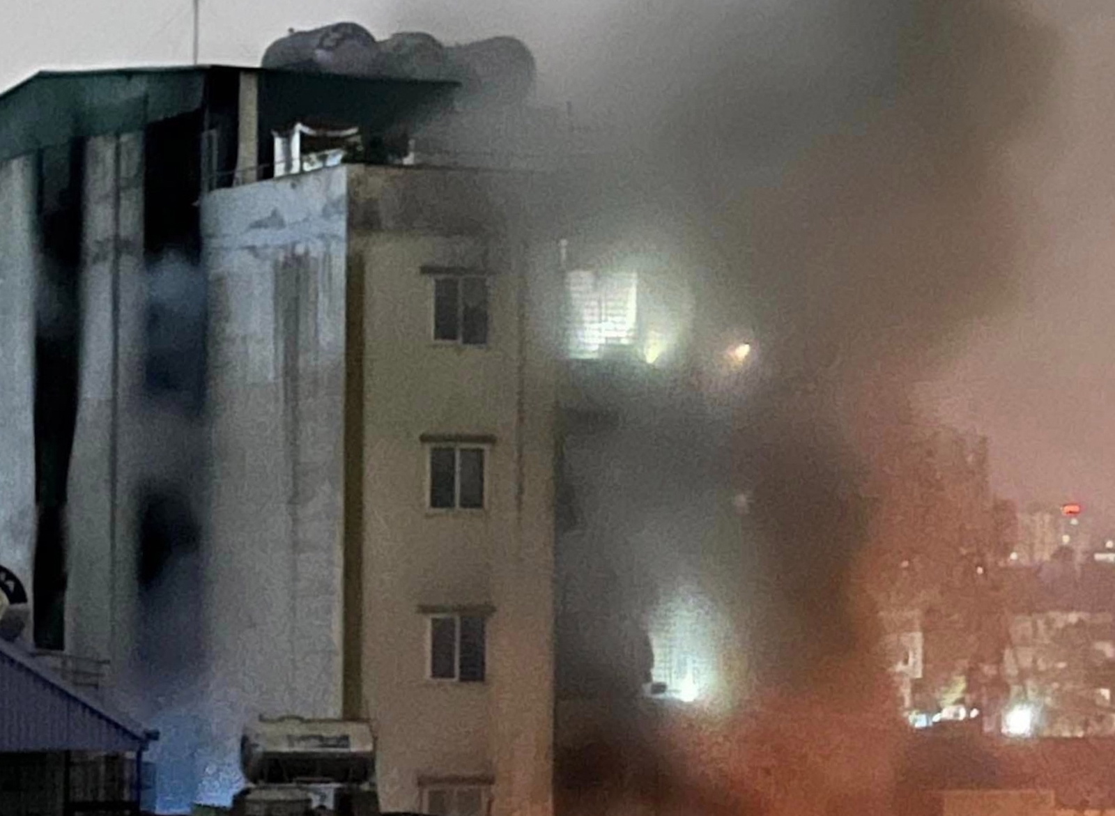 epa10857844 A handout photo made available by Vietnam News Agency (VNA) shows a fire and smoke coming out of an apartment block in Hanoi, Vietnam, 13 September 2023. The fire started on the first floor of the nine-storey apartment at midnight, and was contained by 2am, according to VNA. Many people were believed dead and several injured, according to the official news agency.  EPA/VIETNAM NEWS AGENCY  HANDOUT EDITORIAL USE ONLY/NO SALES