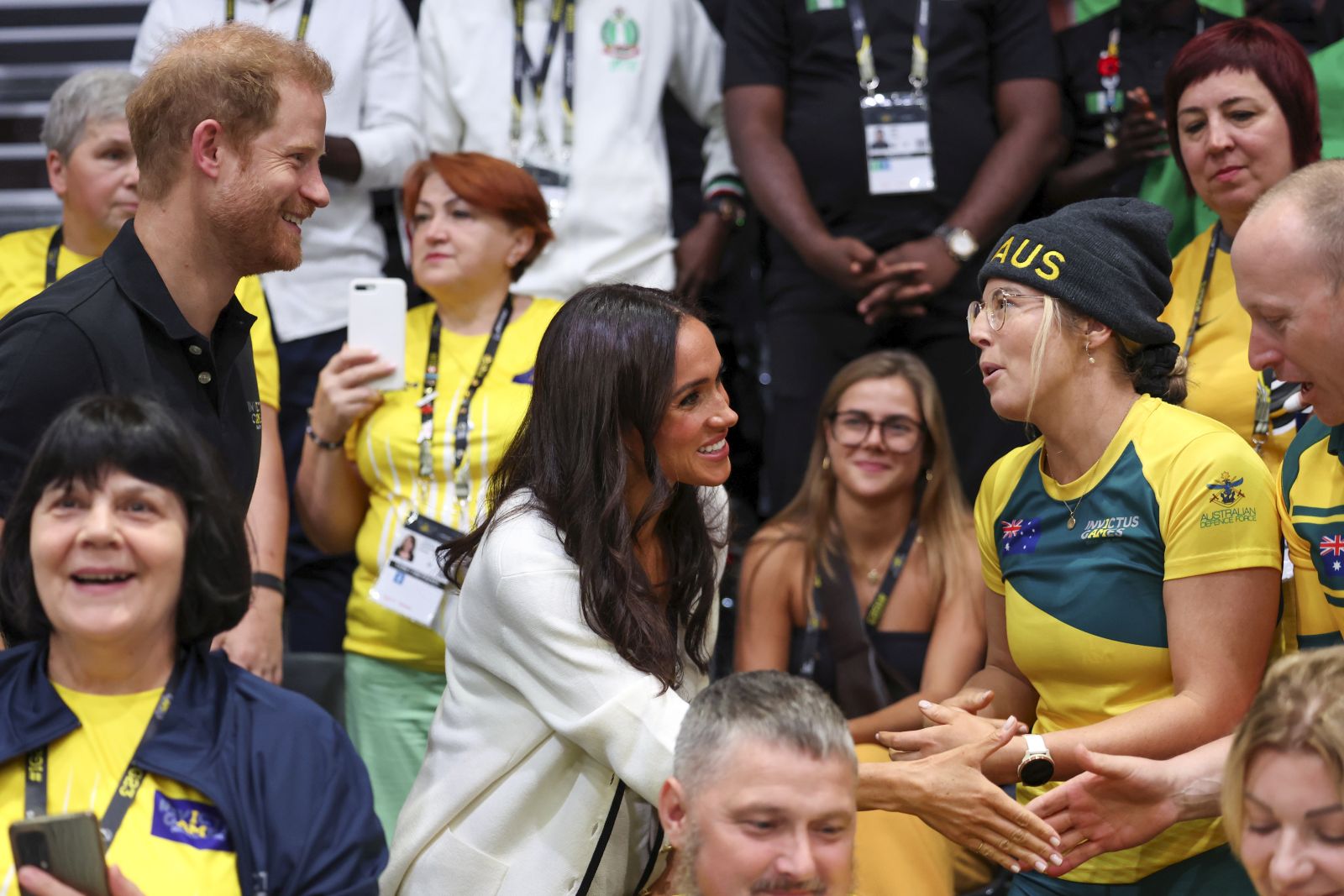 epa10858215 Britain's Prince Harry (L), Duke of Sussex, and his wife Meghan (C), Duchess of Sussex join a Wheelchair Basketball game at the 6th Invictus Games in Duesseldorf, Germany, 13 September 2023. The Invictus Games 2023 will take place from 09 to 16 September in Duesseldorf and are intended for military personnel and veterans who have been psychologically or physically injured in service.  EPA/CHRISTOPHER NEUNDORF