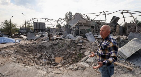 epa10860431 Ukrainian farmer Yakiv Marynchenko, 67, stands in front of a shell crater and a destroyed hangar with agricultural machinery on his farm, near the frontline town of Orikhiv, Zaporizhzhia region, southeastern Ukraine, 14 September 2023. Ukrainian farmer Yakiv Marynchenko, who owns the farm since 1995, cultivates sunflowers, wheat and other grains. He also owned a mill, but it was destroyed when Russian shelling hit his farm at the end of August 2023. The war in Ukraine has significantly impacted food security at the national and global levels, posing a threat to the worldwide food supply, according to the Food and Agriculture Organization of the United Nations (FAO). Russian troops entered Ukrainian territory in February 2022, starting a conflict that has provoked destruction and a humanitarian crisis.  EPA/KATERYNA KLOCHKO