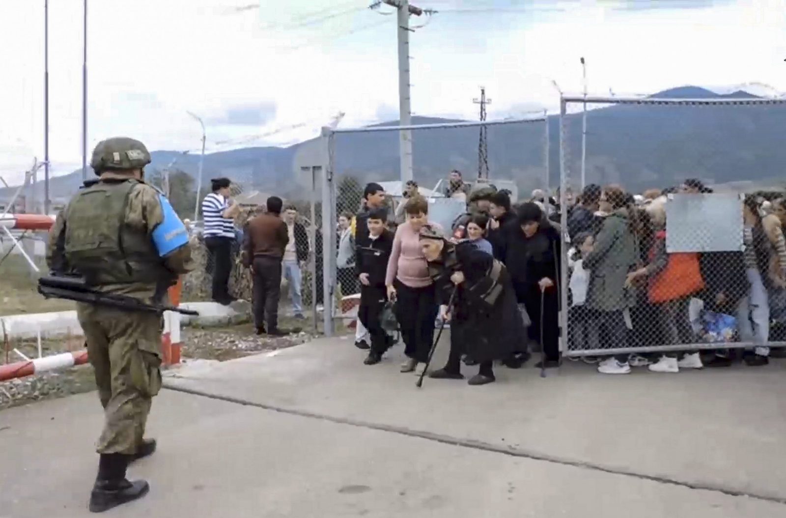 epa10873895 A still image taken from a handout video provided by the Russian Defence Ministry press-service shows civilians entering a Russian peacekeepers' camp near Stepanakert, Nagorno-Karabakh, 21 September 2023. About 5,000 people have been brought to the location of the Russian peacekeeping contingent as Russian peacekeepers have evacuated civilians from Martakert, Martuni, and Askeran districts of Nagorno-Karabakh, the Russian Defence Ministry announced on 21 September. Azerbaijan government's announced that a ceasefire was agreed with Armenian separatists in Nagorno-Karabakh on 20 September, after a 24-hour military offensive to take control of the enclave.  EPA/RUSSIAN DEFENCE MINISTRY PRESS SERVICE HANDOUT -- MANDATORY CREDIT -- BEST QUALITY AVAILABLE -- HANDOUT EDITORIAL USE ONLY/NO SALES