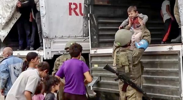epa10882540 A still image taken from a handout video provided by the Russian Defence Ministry press-service shows Russian peacekeepers evacuating Nagorno-Karabakh civilians at an undisclosed location, 25 September 2023. Over the past 24 hours, Russian military personnel ensured the delivery of 190 tons of cargo with food and fuel and other aid for the civilian population of Karabakh, the Russian Ministry of Defence said on 25 September. Russian peacekeepers escorted the transport of civilians from the Martuni region, delivering 70 people to Stepanakert, the ministry added. Some 715 civilians, including 402 children, have been taken to the Russian peacekeeping contingent, where they have been provided with accommodation, food and medical assistance. Azerbaijan on 19 September 2023 launched a brief military offensive on the contested region of Nagorno-Karabakh, a breakaway enclave that is home to some 120,000 ethnic Armenians. The Armenian government announced the evacuation of about 3,000 local residents from the region following the ceasefire agreed on 20 September 2023, as Azerbaijan opened all checkpoints with Armenia for the unimpeded exit of civilians from the territory of Nagorno-Karabakh. Russian peacekeepers escorted convoys of civilians from Nagorno-Karabakh leaving for Armenia, the Russian Ministry of Defense reported.  EPA/RUSSIAN DEFENCE MINISTRY PRESS SERVICE HANDOUT -- MANDATORY CREDIT -- BEST QUALITY AVAILABLE -- HANDOUT EDITORIAL USE ONLY/NO SALES