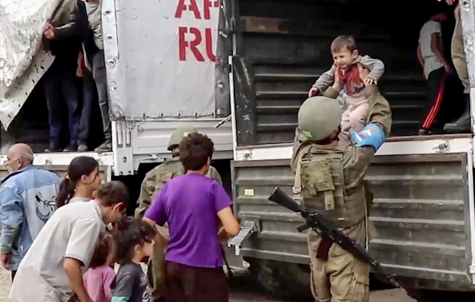 epa10882540 A still image taken from a handout video provided by the Russian Defence Ministry press-service shows Russian peacekeepers evacuating Nagorno-Karabakh civilians at an undisclosed location, 25 September 2023. Over the past 24 hours, Russian military personnel ensured the delivery of 190 tons of cargo with food and fuel and other aid for the civilian population of Karabakh, the Russian Ministry of Defence said on 25 September. Russian peacekeepers escorted the transport of civilians from the Martuni region, delivering 70 people to Stepanakert, the ministry added. Some 715 civilians, including 402 children, have been taken to the Russian peacekeeping contingent, where they have been provided with accommodation, food and medical assistance. Azerbaijan on 19 September 2023 launched a brief military offensive on the contested region of Nagorno-Karabakh, a breakaway enclave that is home to some 120,000 ethnic Armenians. The Armenian government announced the evacuation of about 3,000 local residents from the region following the ceasefire agreed on 20 September 2023, as Azerbaijan opened all checkpoints with Armenia for the unimpeded exit of civilians from the territory of Nagorno-Karabakh. Russian peacekeepers escorted convoys of civilians from Nagorno-Karabakh leaving for Armenia, the Russian Ministry of Defense reported.  EPA/RUSSIAN DEFENCE MINISTRY PRESS SERVICE HANDOUT -- MANDATORY CREDIT -- BEST QUALITY AVAILABLE -- HANDOUT EDITORIAL USE ONLY/NO SALES
