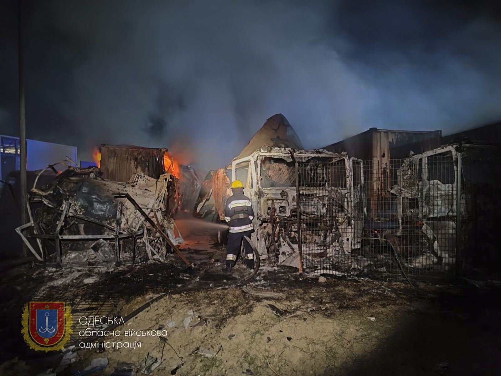 epa10883296 A handout photo made available by the Odesa Regional State Administration shows rescuers working to put down a fire after an overnight attack of a seaport infrastructure object in the Odesa region, southern Ukraine, 26 September 2023. At least two people were injured in the attack according to Oleg Kiper, the Head of Odesa Regional State Administration. Russian troops entered Ukrainian territory in February 2022, starting a conflict that has provoked destruction and a humanitarian crisis.  EPA/ODESA REGIONAL STATE ADMINISTRATION / HANDOUT HANDOUT  HANDOUT EDITORIAL USE ONLY/NO SALES