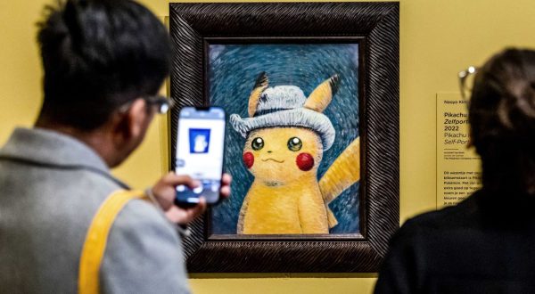 epaselect epa10888485 Visitors look at a painting by an artist who was inspired by Vincent van Gogh's work, at the Van Gogh Museum in Amsterdam, the Netherlands, 28 September 2023. Some of Vincent van Gogh's best-known works inspired six paintings that artists from The Pokemon Company have created of Pokemon. The exhibition runs from 28 September to 07 January 2024.  EPA/REMKO DE WAAL