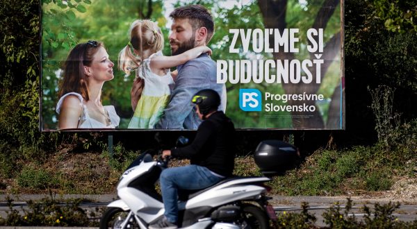 epa10890160 A man rides a scooter past an election poster of leader of Progresivne Slovensko party (Progressive Slovakia) Michal Simecka with a slogan that reads 'Let's choose the future', in Bratislava, Slovakia, 29 September 2023. Slovakia will be holding parliamentary elections on 30 September 2023.  EPA/MARTIN DIVISEK